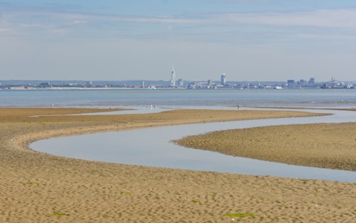 a beach in Ryde with a city called Portsmouth in the background