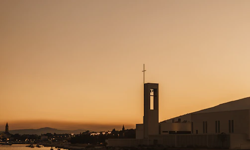 A peaceful sunset view over the Fazenda Passos SDA church building with the Rio Grande do Sul landscape.