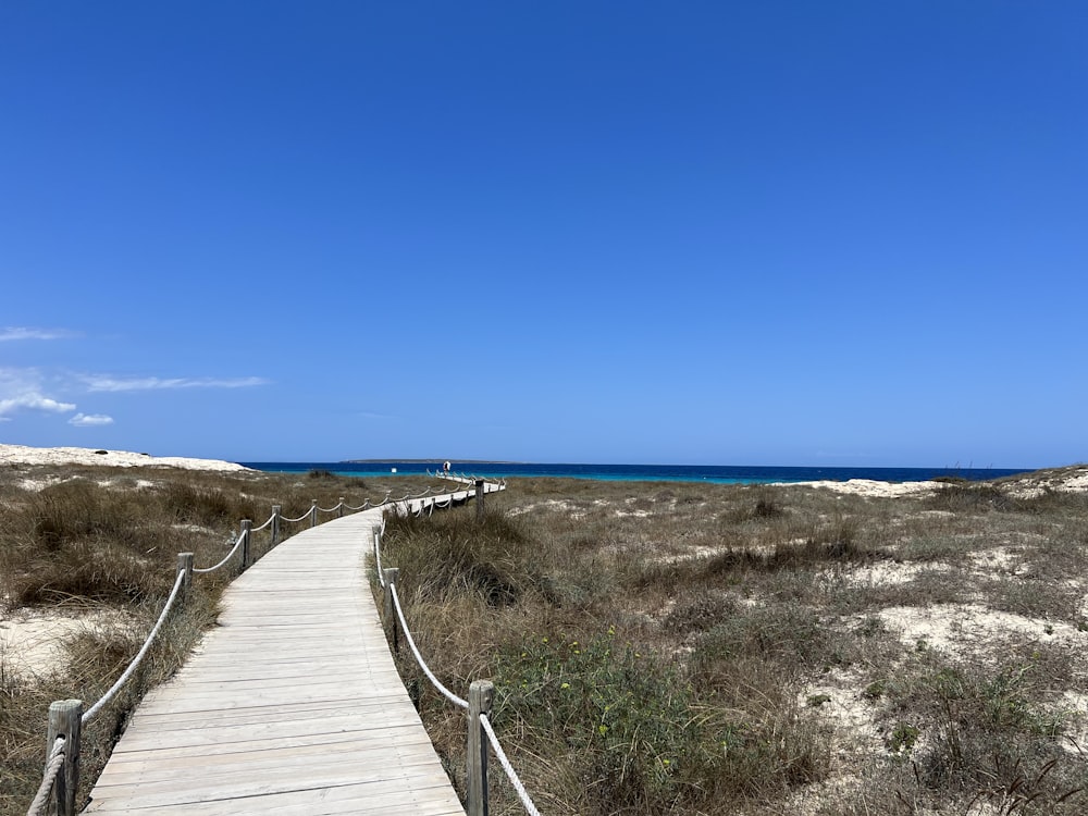 a wooden walkway to a beach