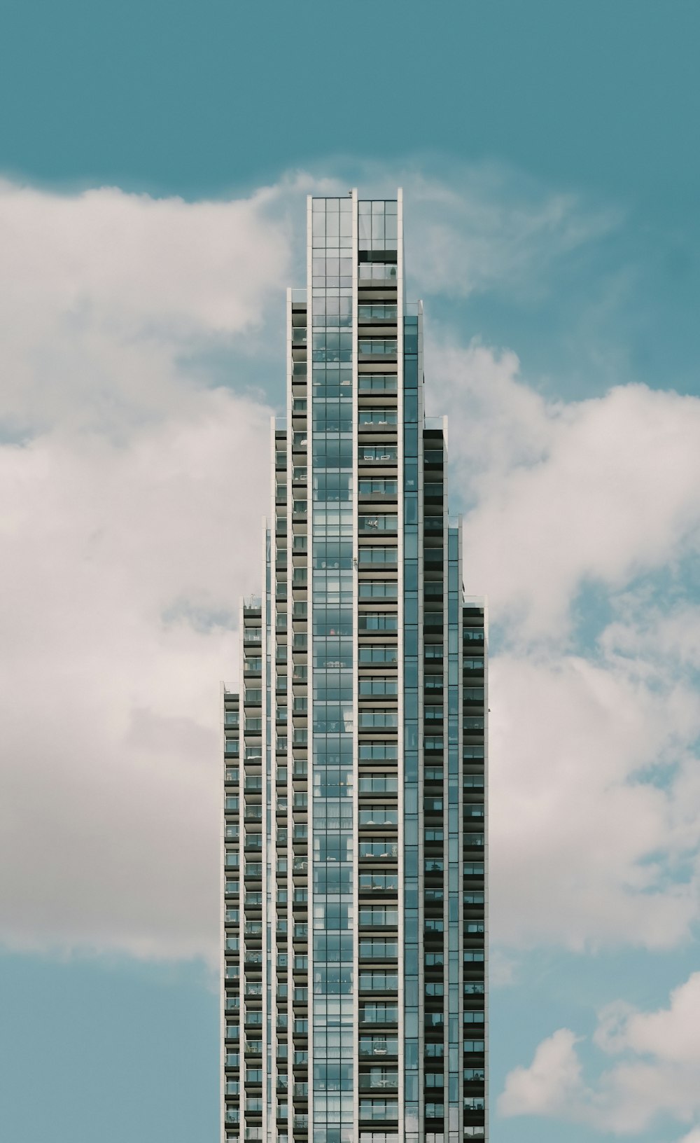 a tall building with a cloudy sky