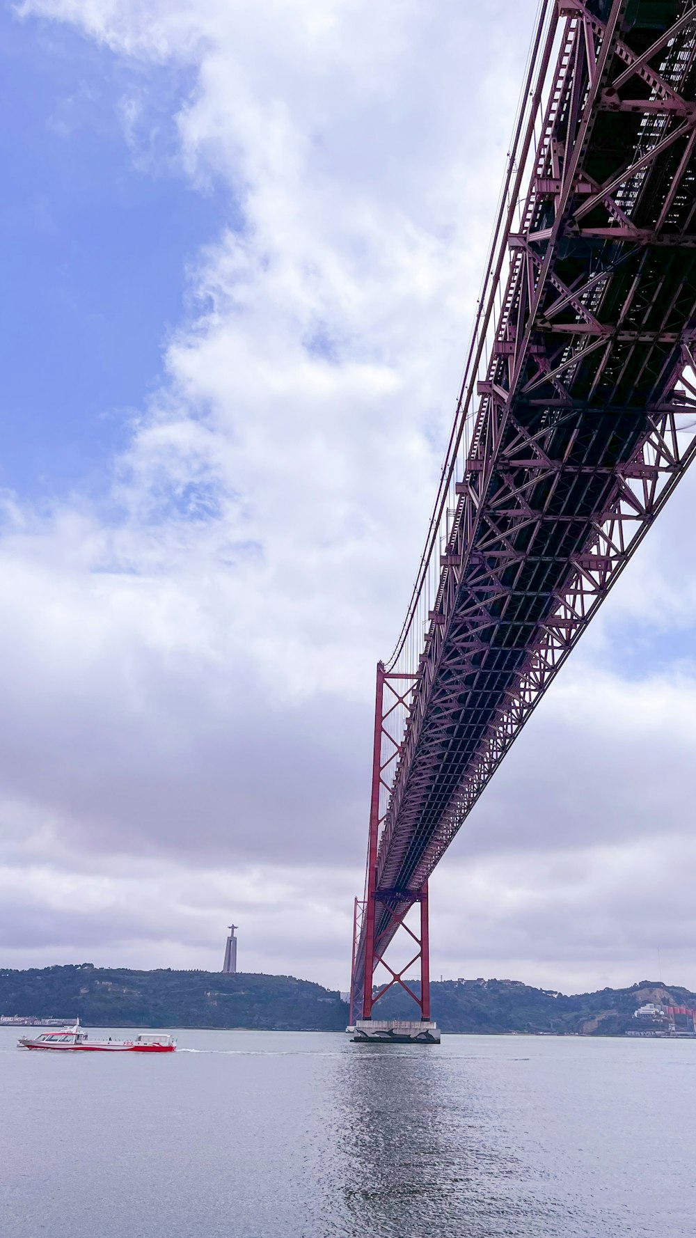 a large red bridge over water