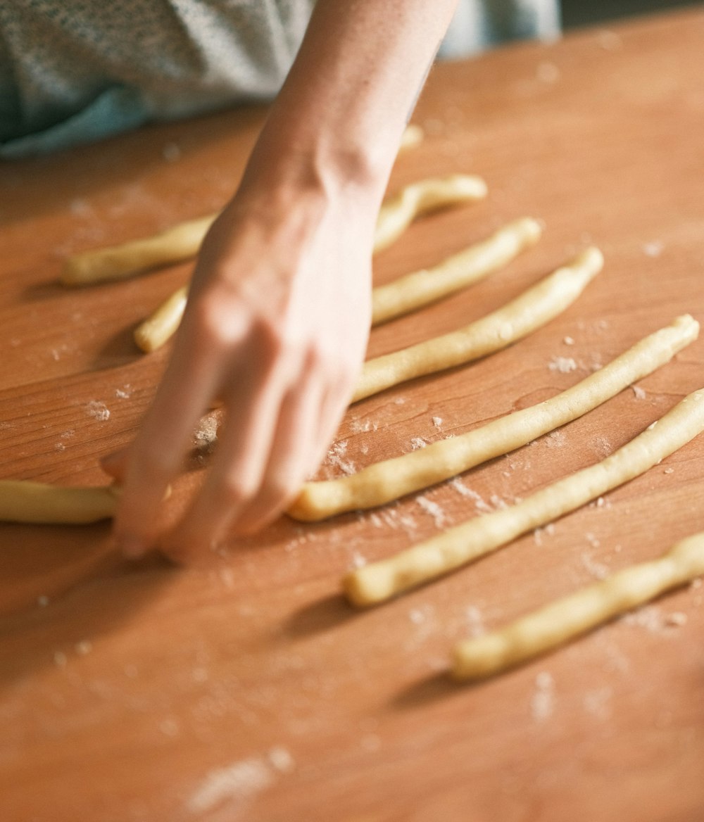a person cutting up french fries