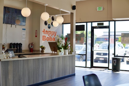 a counter with a glass door and a glass window with a plant on it