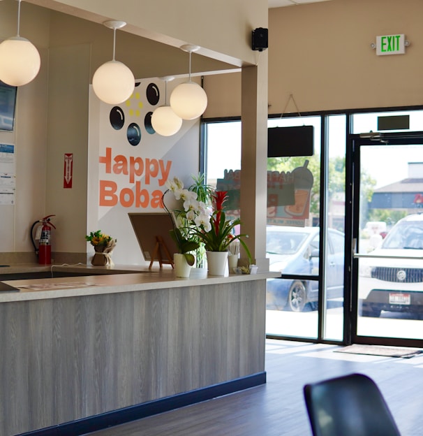 a counter with a glass door and a glass window with a plant on it