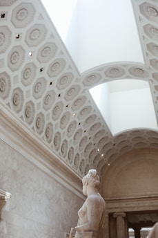 A marble column bathed in soft golden light, evoking ancient Greek wisdom and strength.