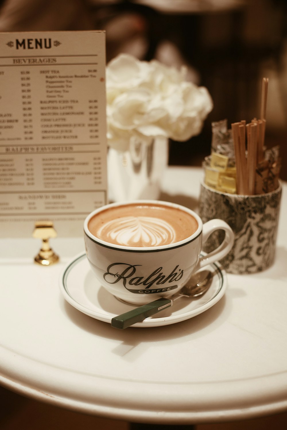 a cup of coffee with a flower on the side