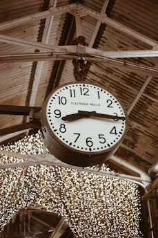 A cozy clock on a wall showing business hours in a welcoming environment.