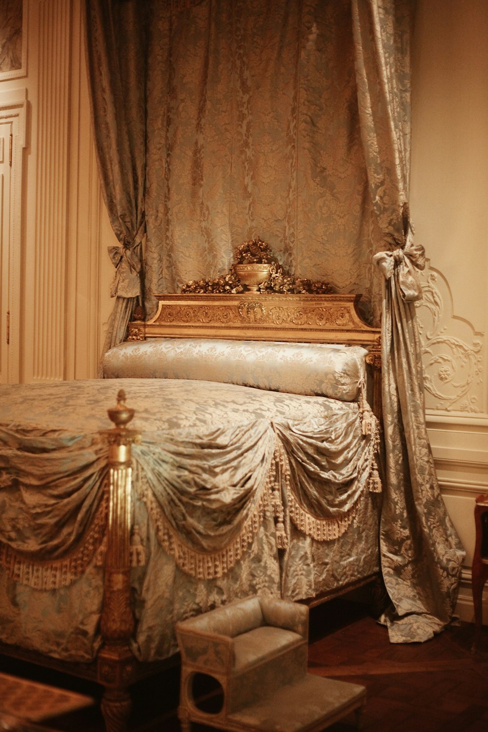 a bed with a gold headboard