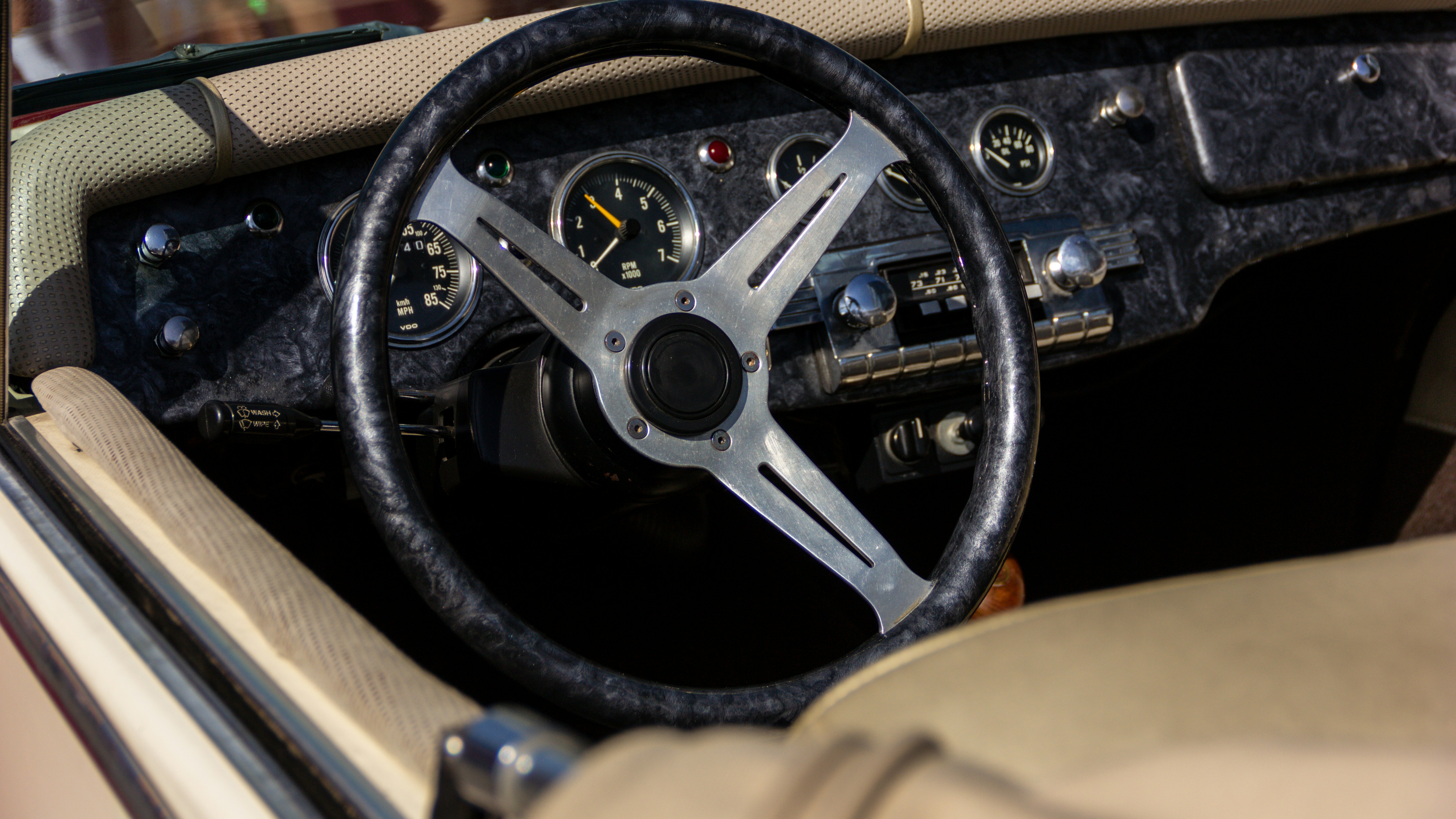 Close-up of a classic Volkswagen Beetle interior dashboard with vintage details.