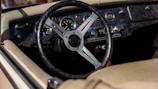 Detailed shot of a vintage car’s dashboard with leather and brass accents.