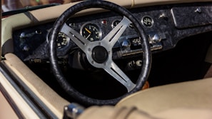 Detailed shot of a vintage car’s dashboard with leather and brass accents.