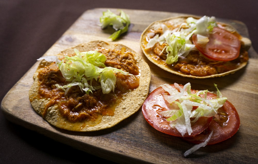 a group of tacos on a wooden surface
