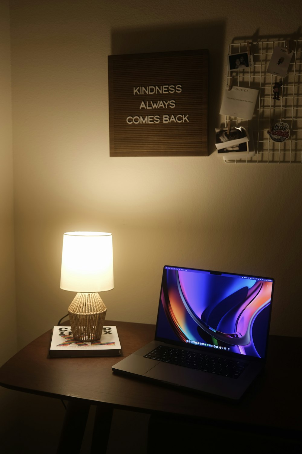 a laptop and a lamp on a desk