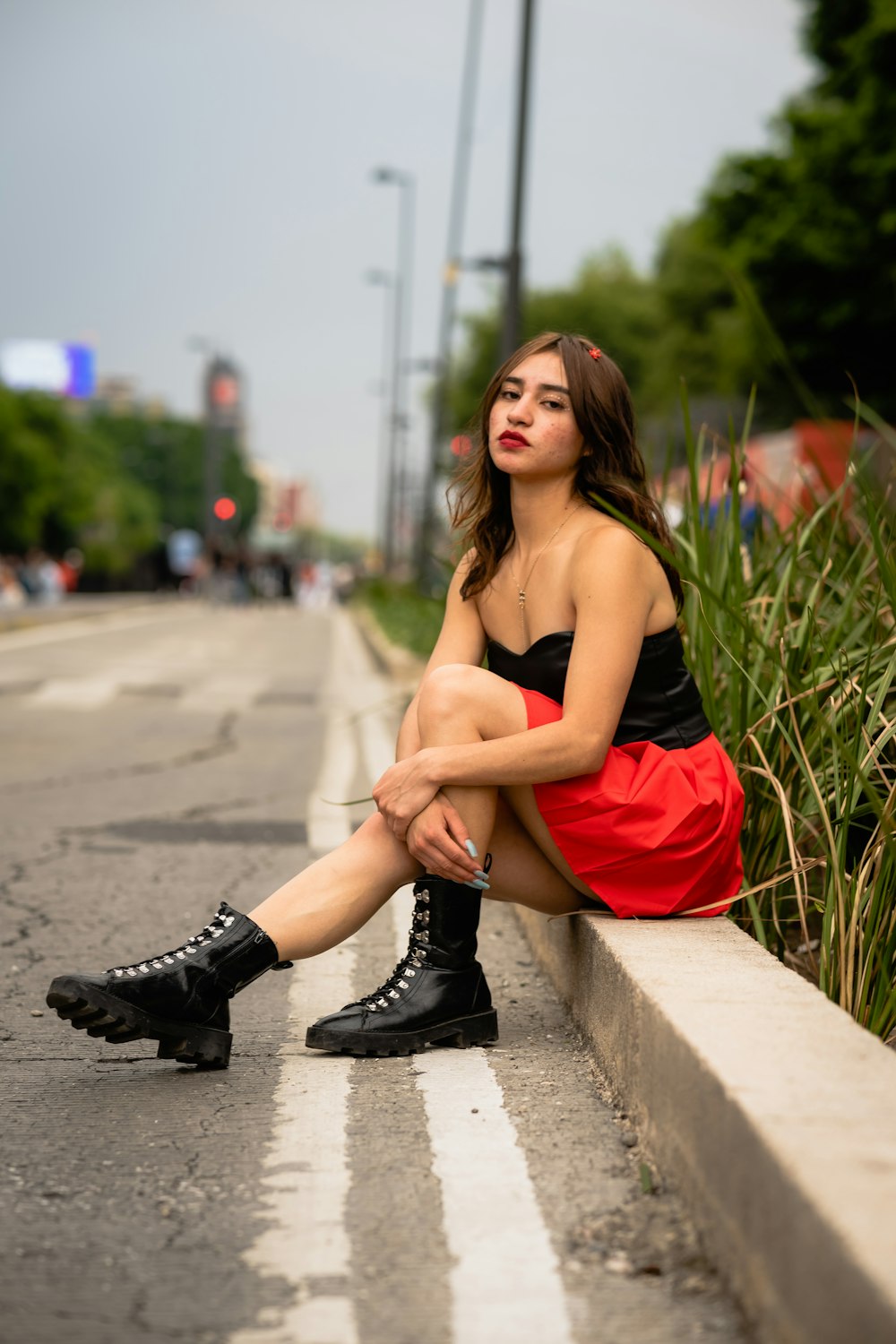 a woman sitting on a curb