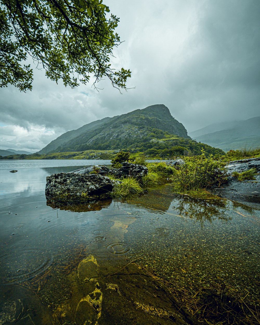 a body of water with a mountain in the background