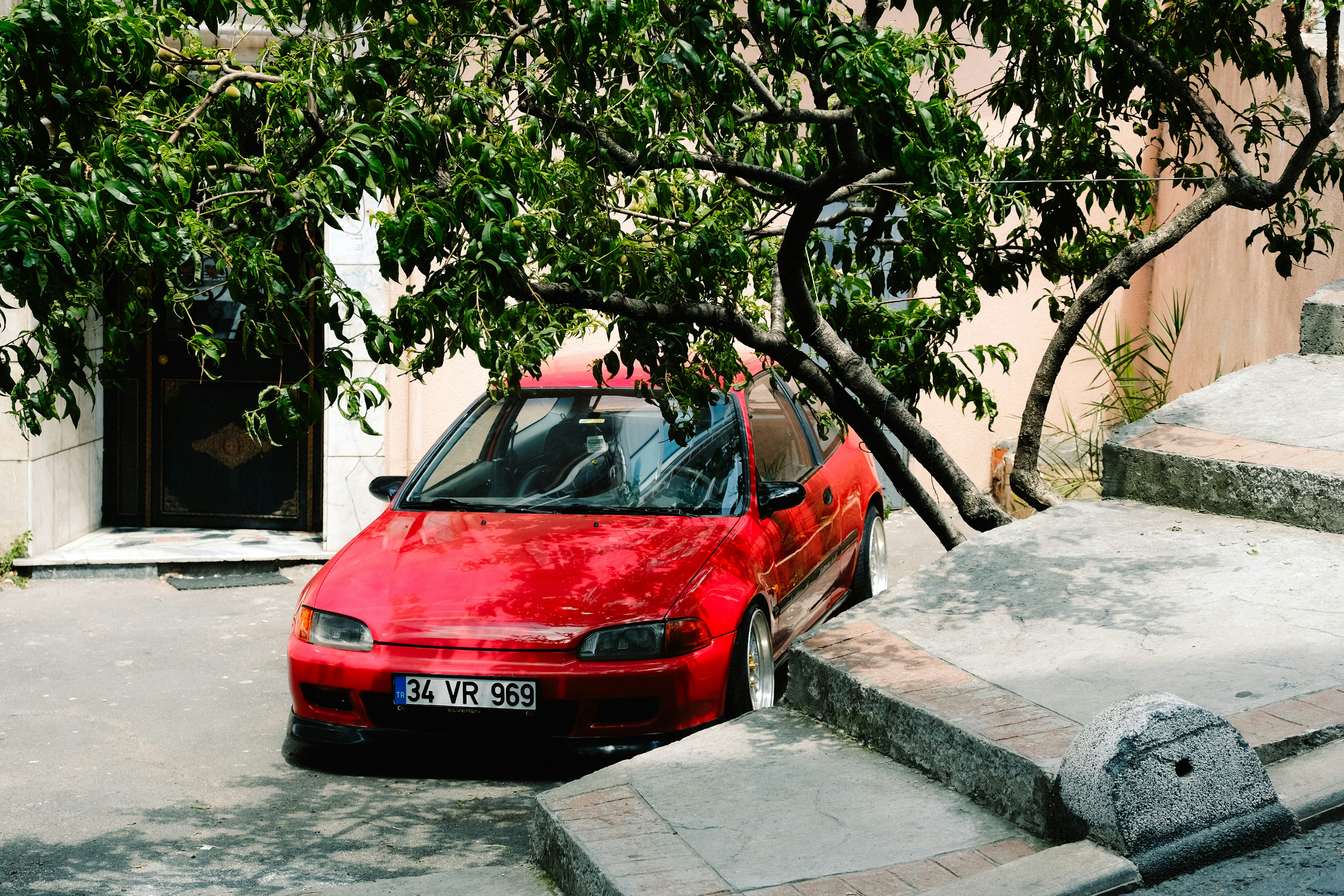 a red car parked on the side of a road