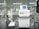 A laboratory setting featuring a water purification system with the brand name Rephile displayed on it. The setup includes a control unit with a digital display screen and an attached dispenser with a control panel. The background shows lab shelves and equipment, indicating a clean, sterile environment.