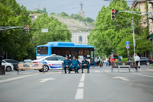 a group of people sit on a bench in the middle of a street
