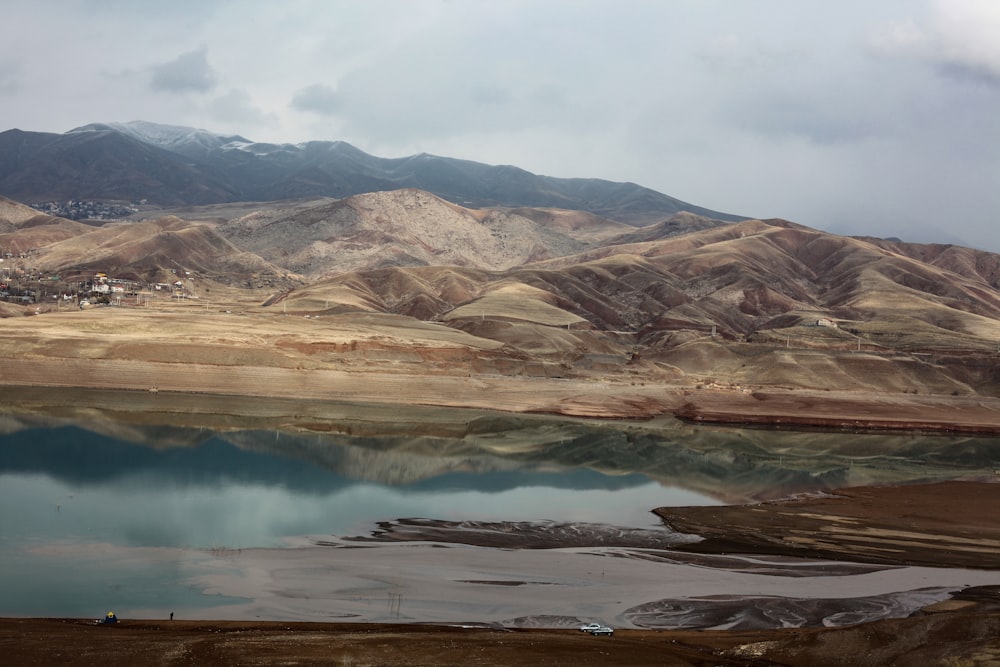 a body of water with a mountain in the background