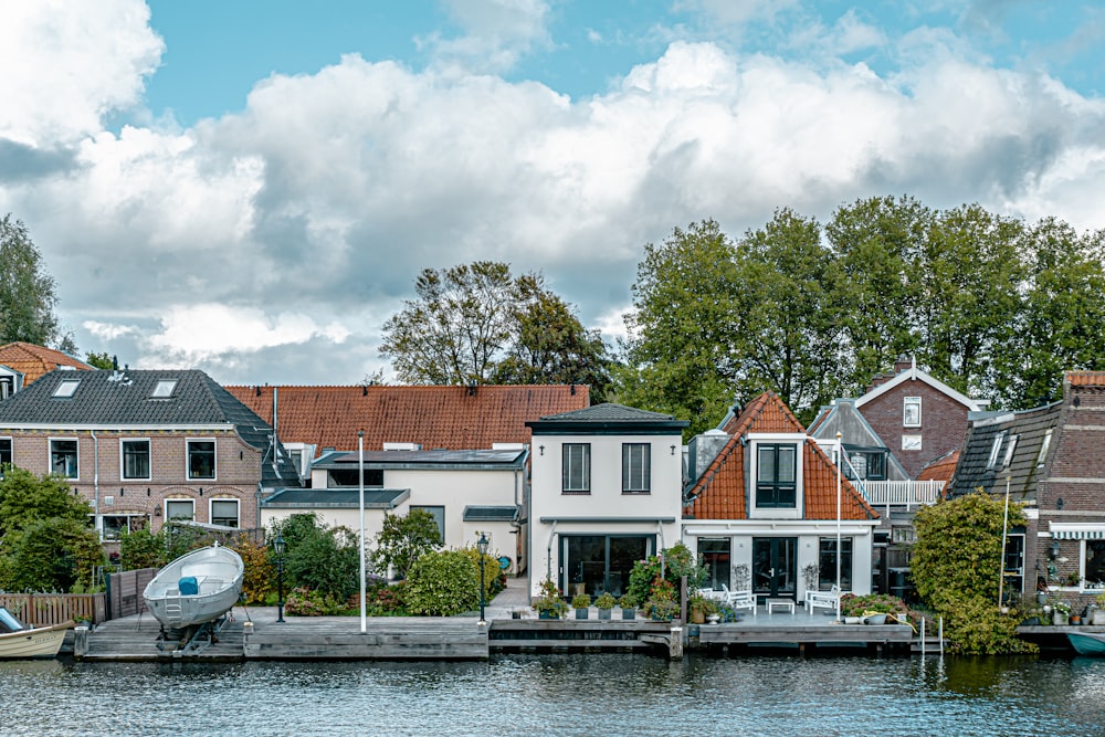 a small boat in a body of water in front of a house