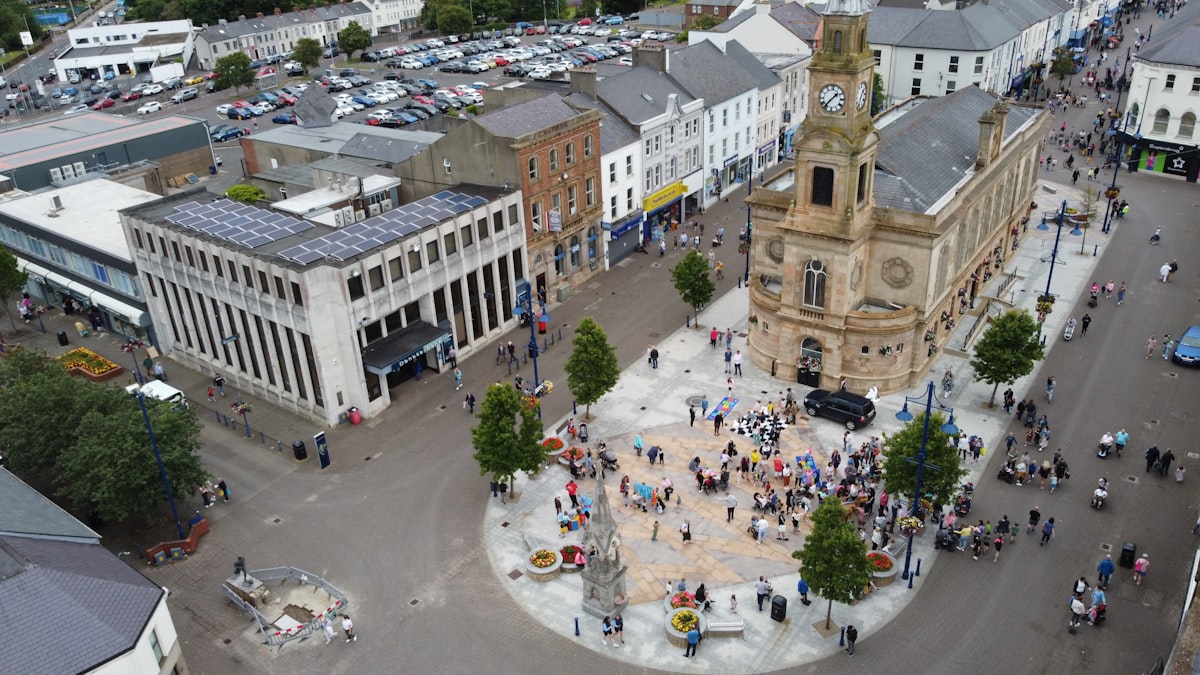 A gathering of people assembled in a city square, community assembly