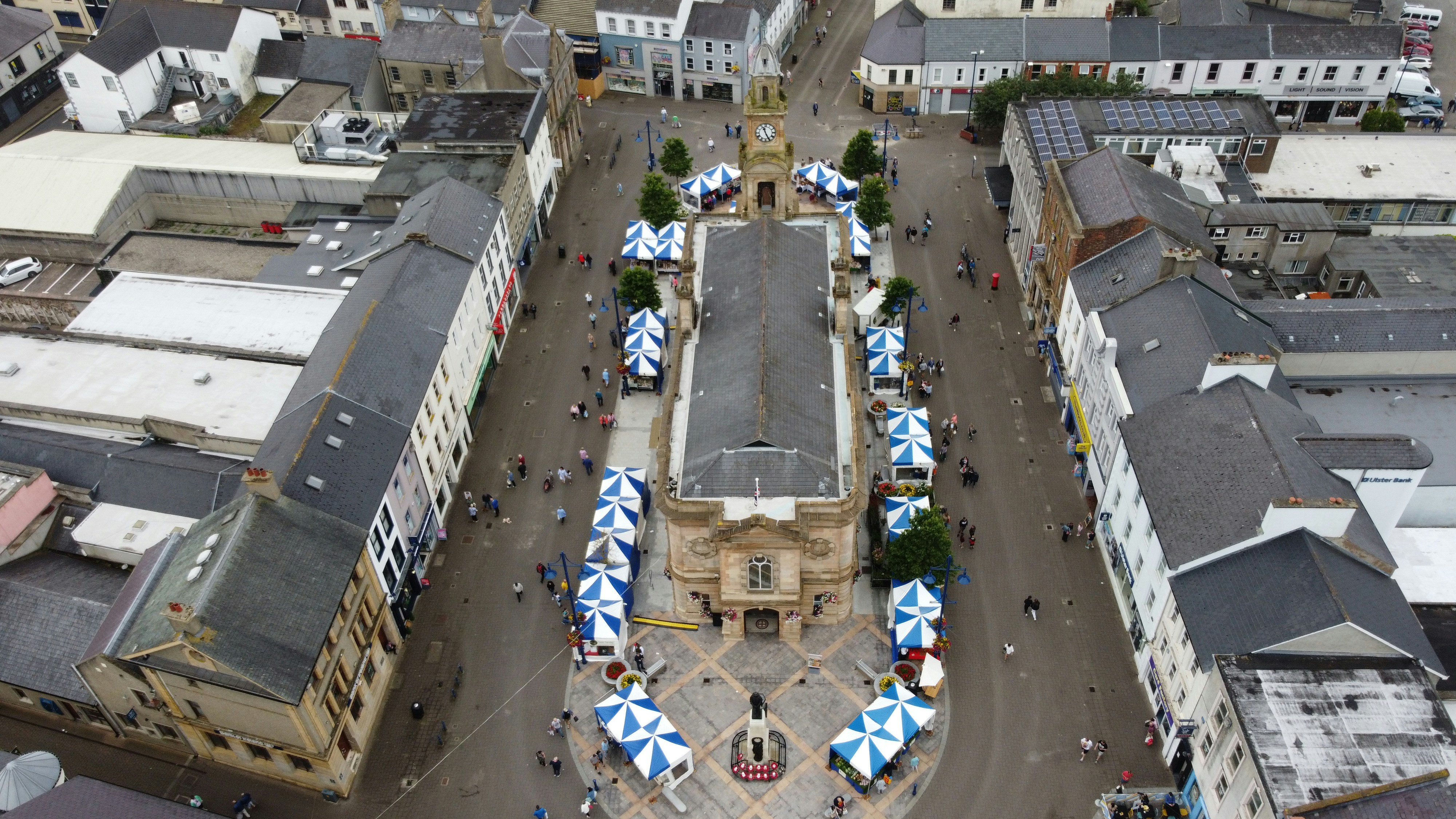a group of people walking around a city