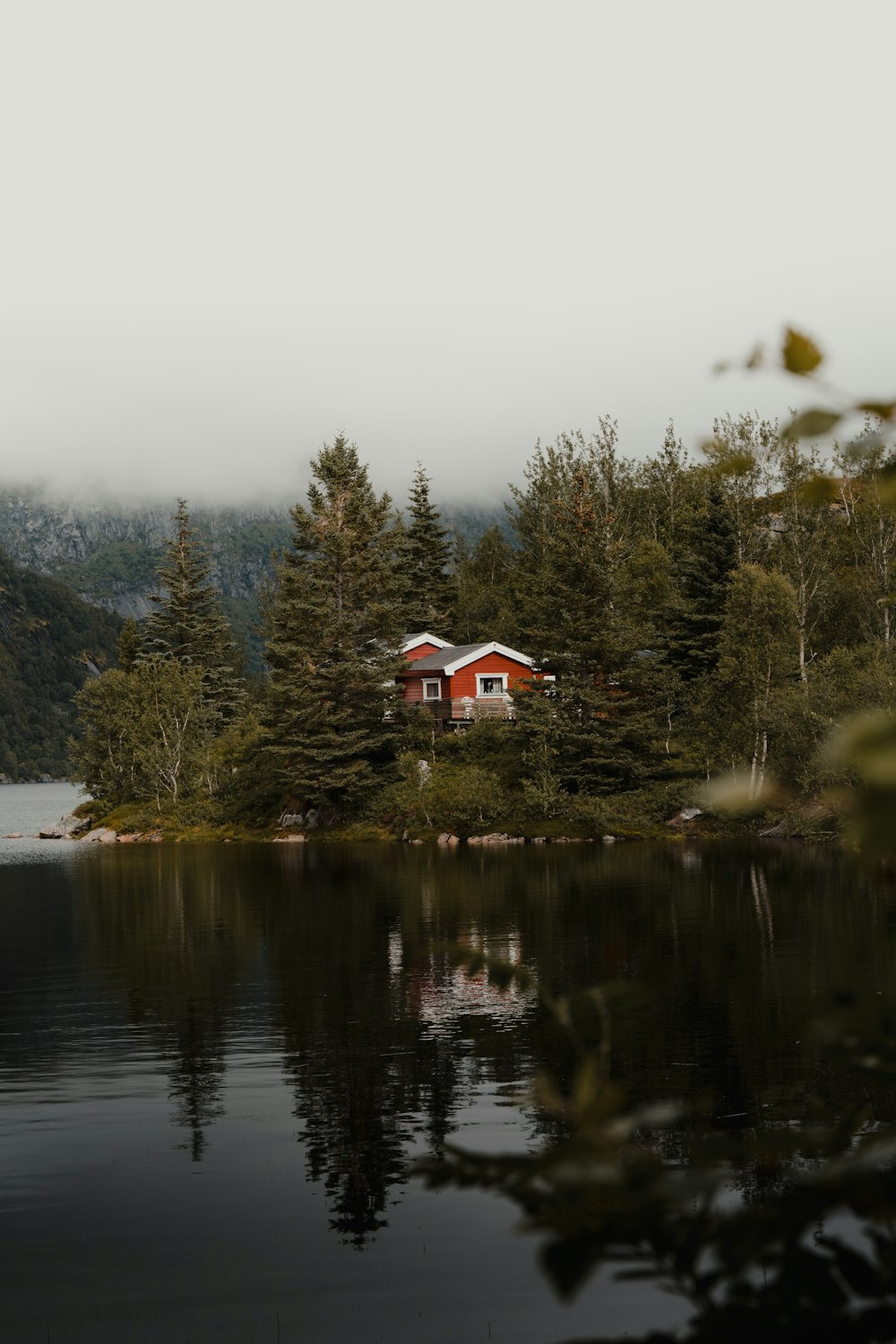 a house on a hill by a lake