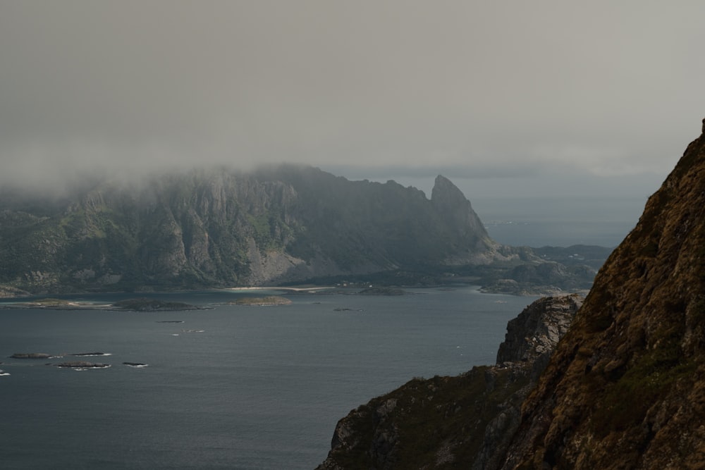 a body of water with mountains in the back