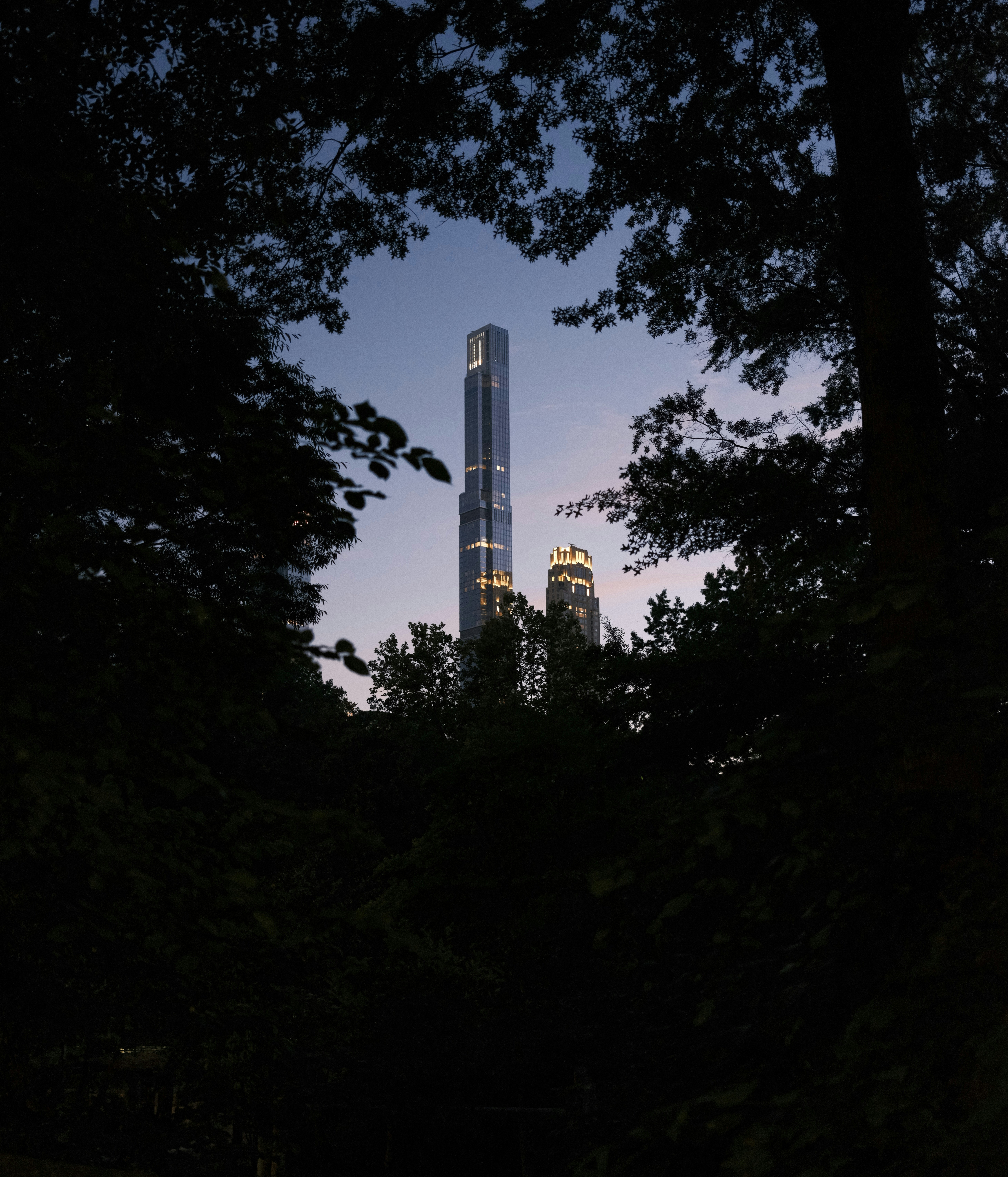 A tall building behind trees photo – Free Grey Image on Unsplash