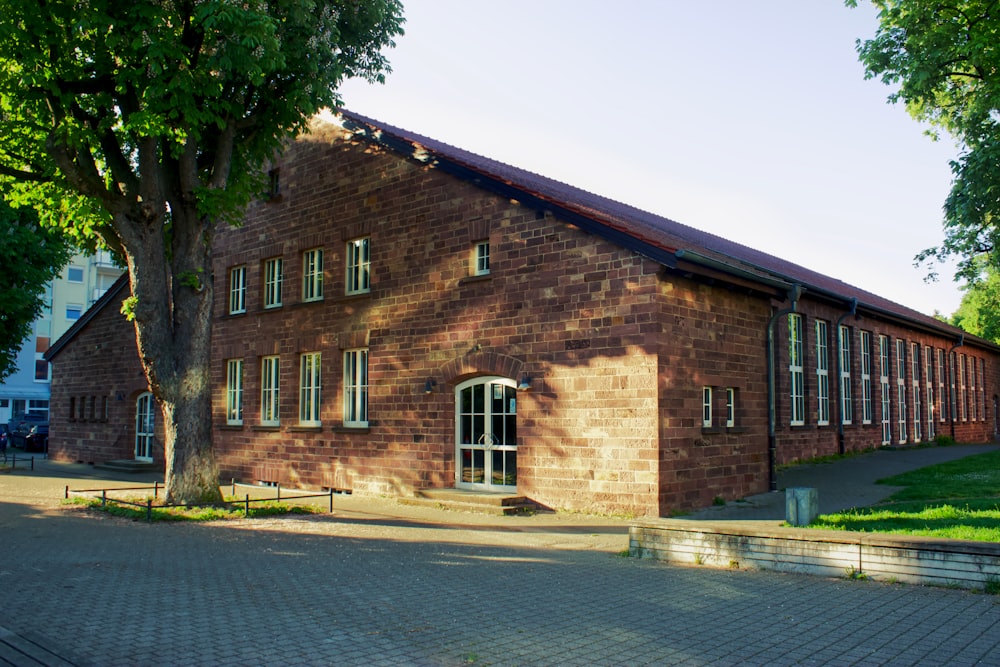 a brick building with a tree in front of it