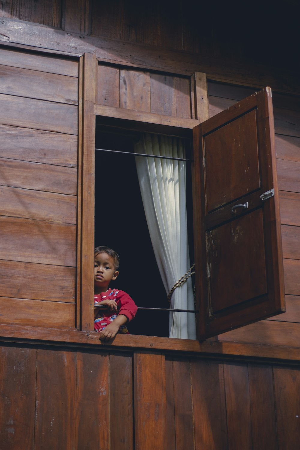 a child sitting in a window