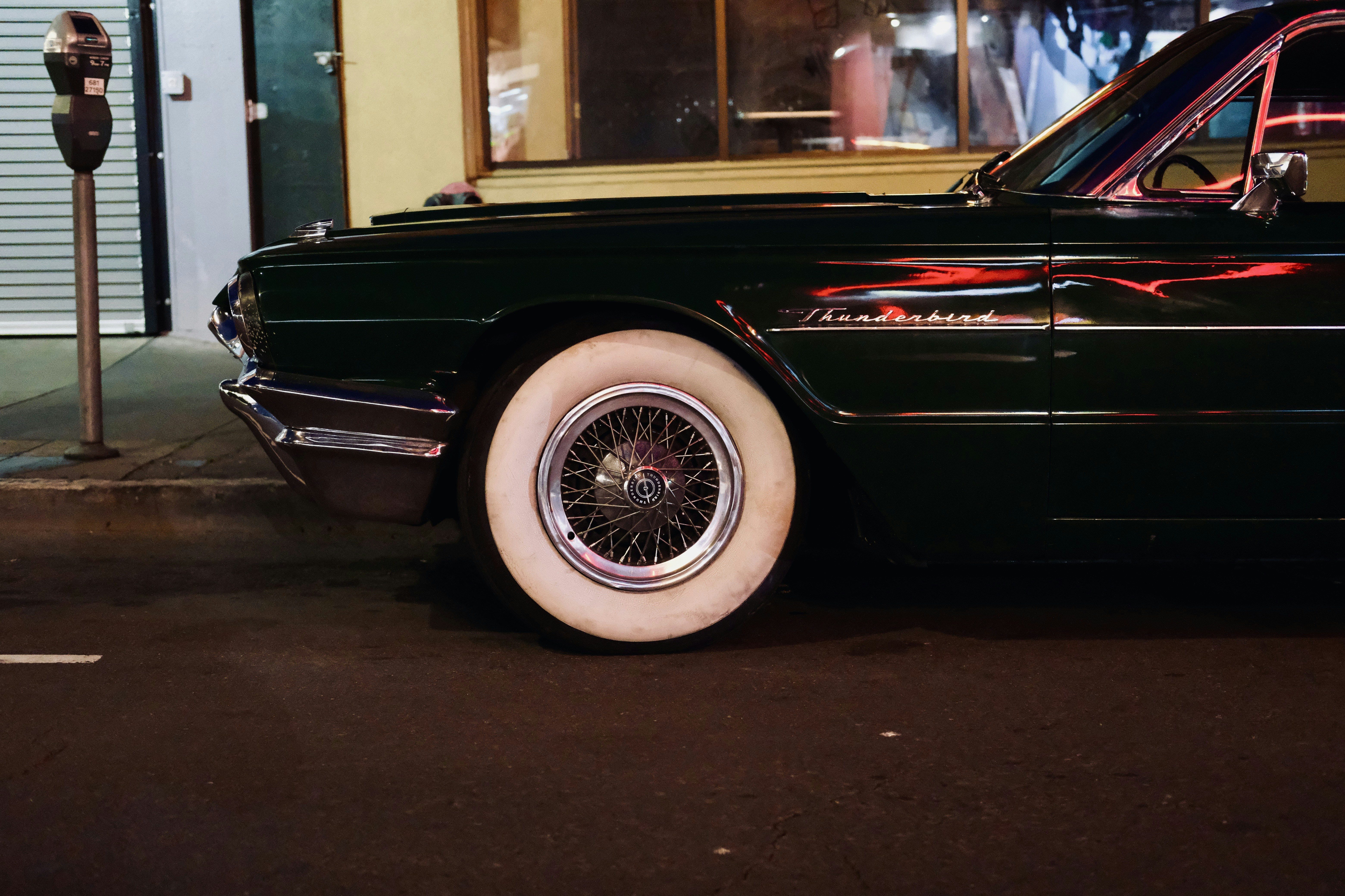 a black car parked on the side of a street