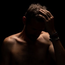 a man with his hands on his face