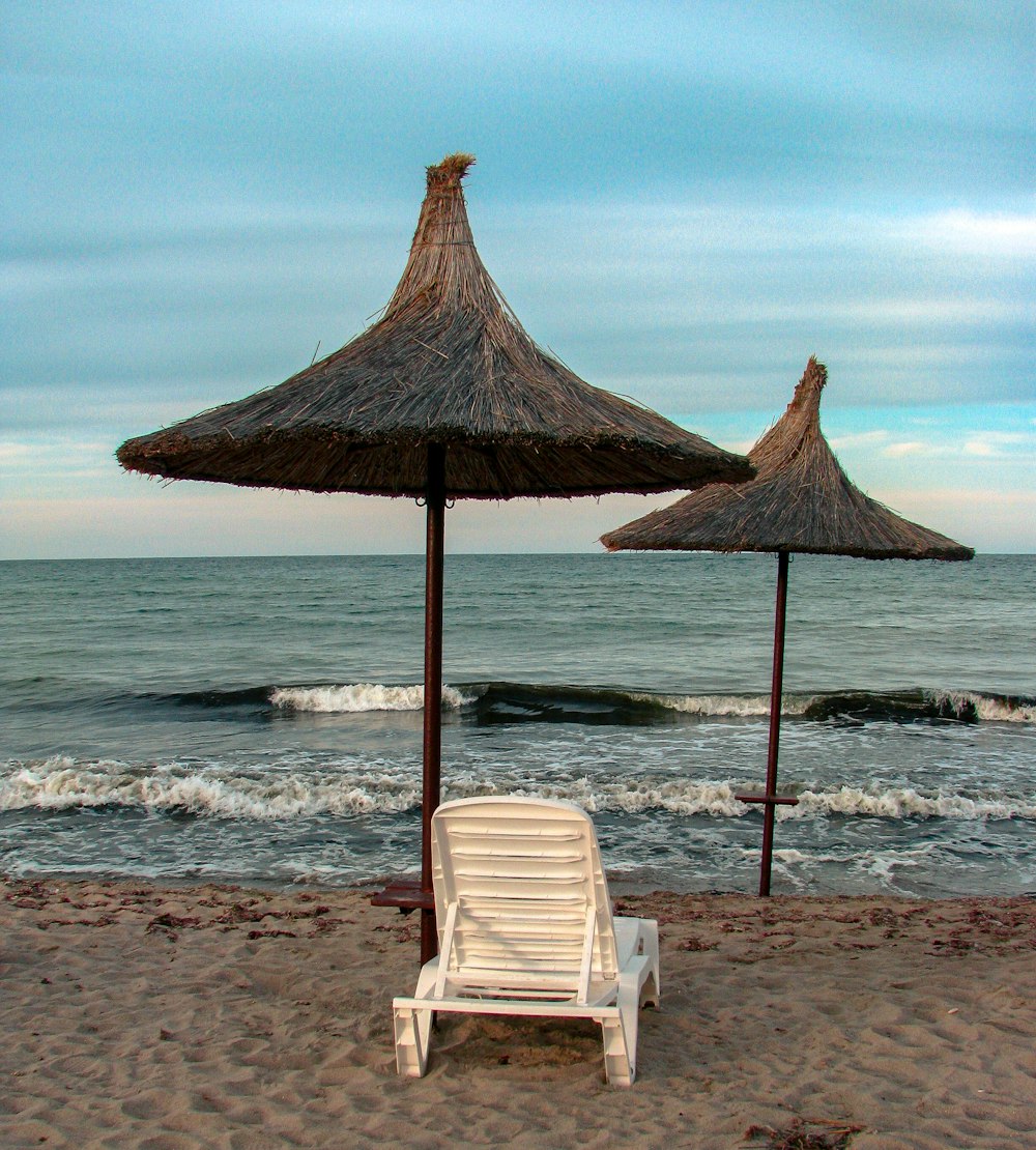 uma cadeira e guarda-sol em uma praia