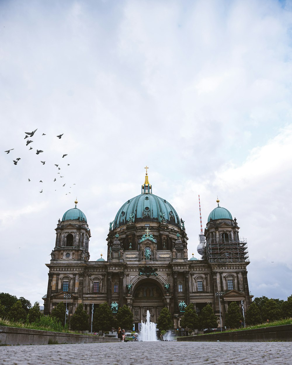 a large building with a fountain in front of it