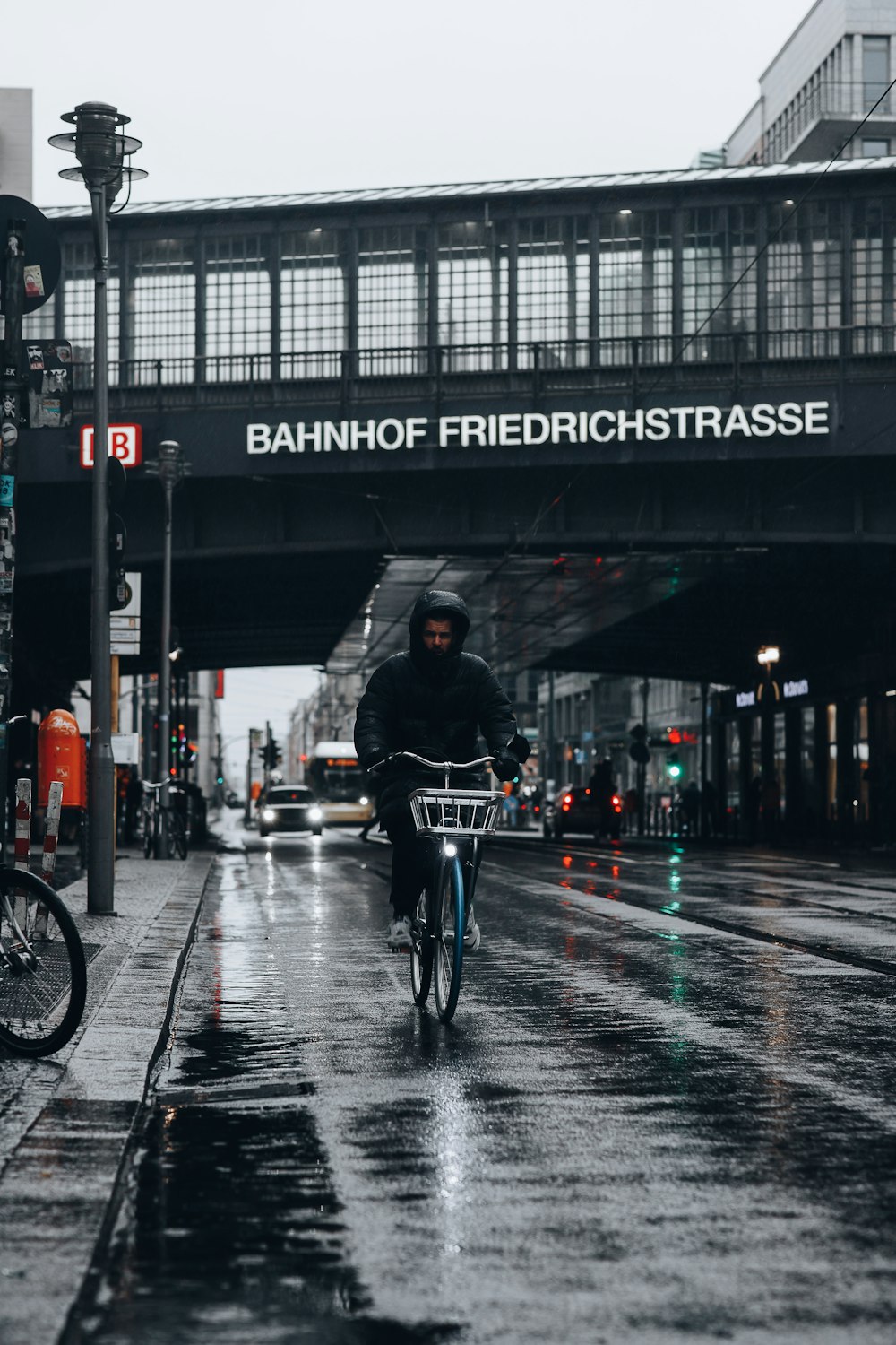 a man riding a bicycle under a bridge