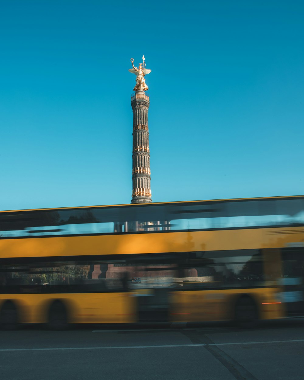 a bus driving past a tall tower