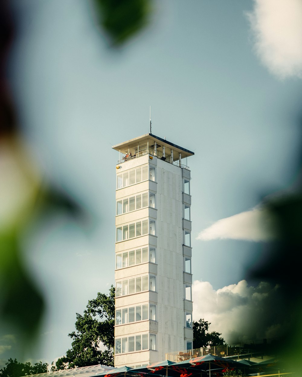 a tall building with a cloudy sky