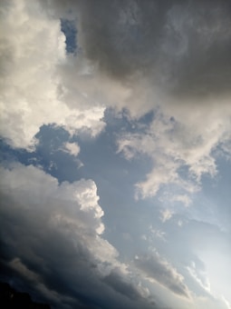 The image features a sky with a combination of light and dark clouds. The lower part of the sky appears clearer with patches of blue, while the upper part is dominated by thick, dark clouds indicating an overcast or stormy weather condition.
