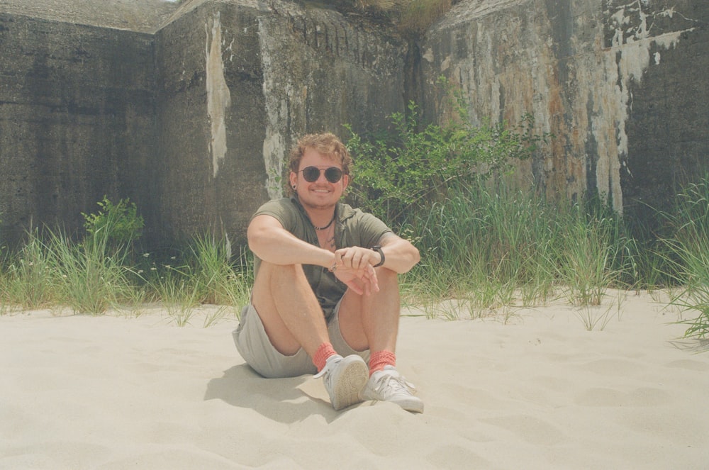 a person sitting on sand