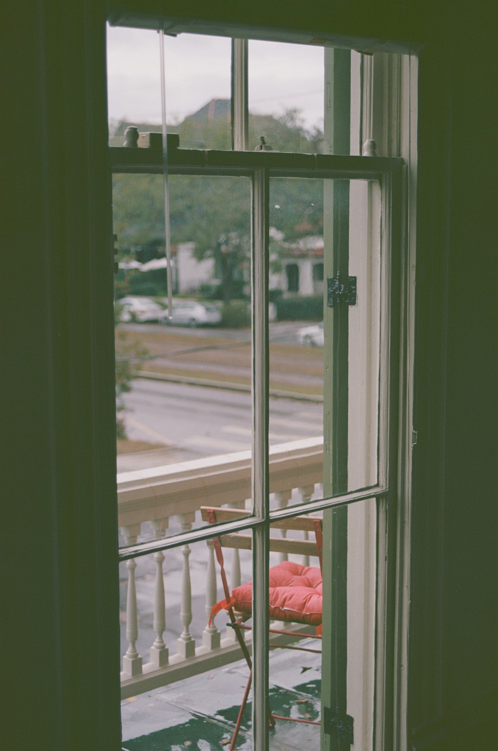 a window with a view of a street and cars