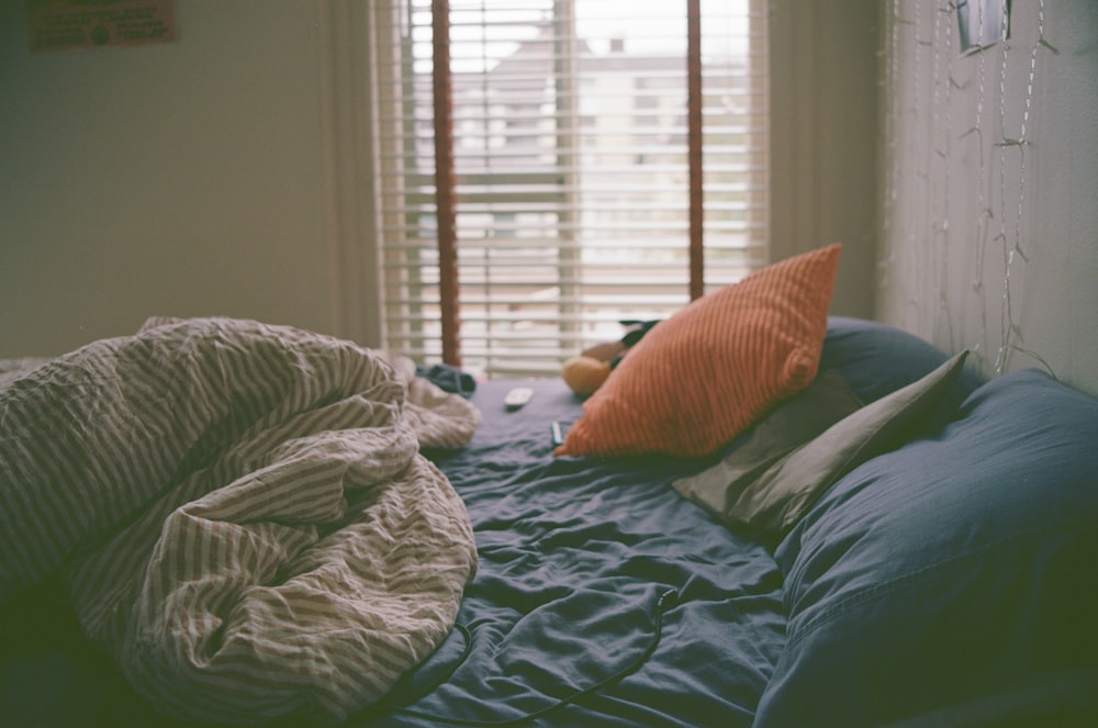 a bed with a blanket and pillows