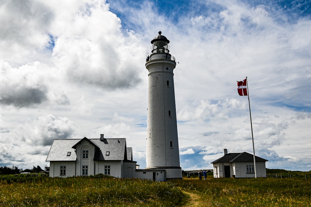 ein Leuchtturm mit einer Flagge mit New Presque Isle Light im Hintergrund