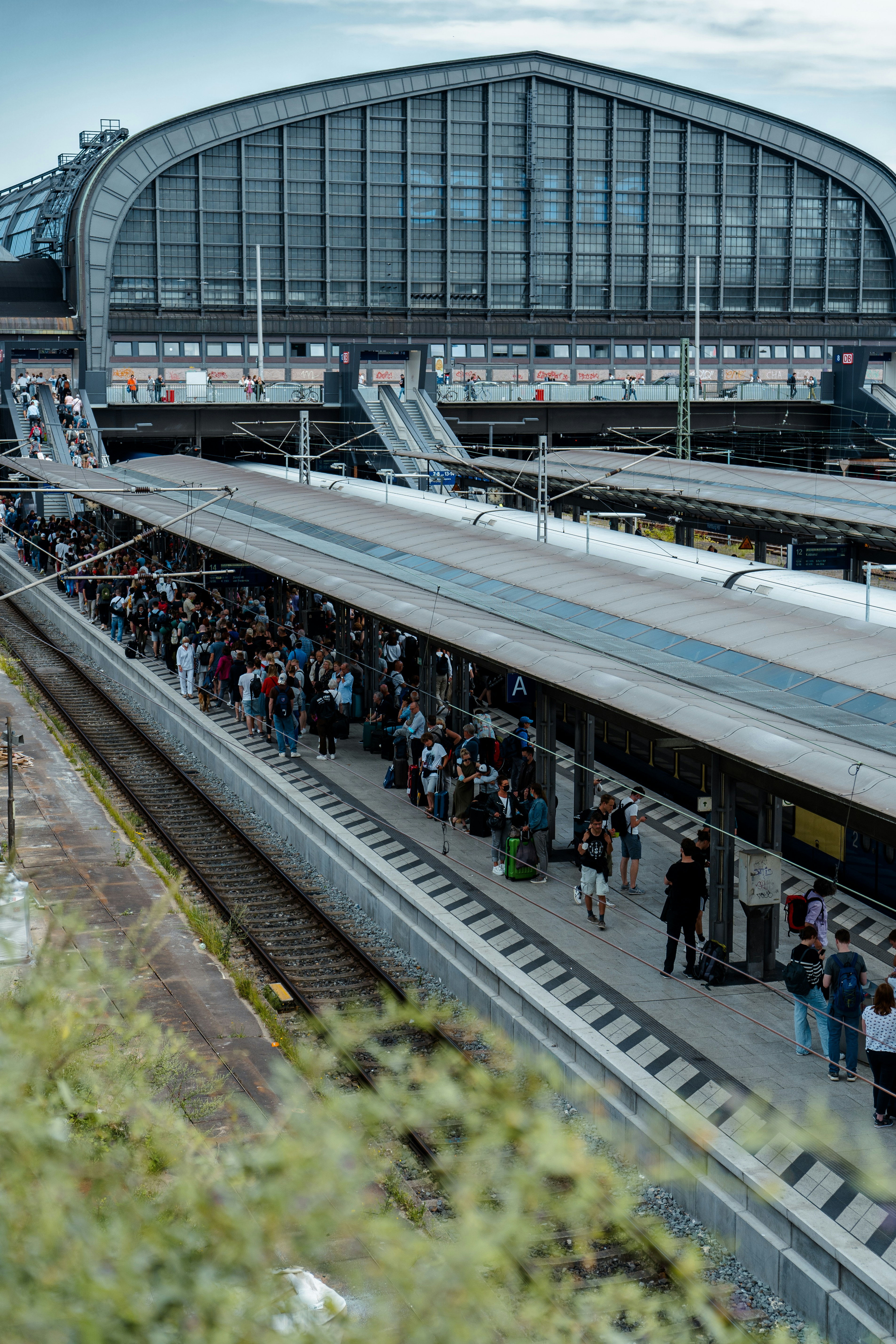 a train station with people waiting