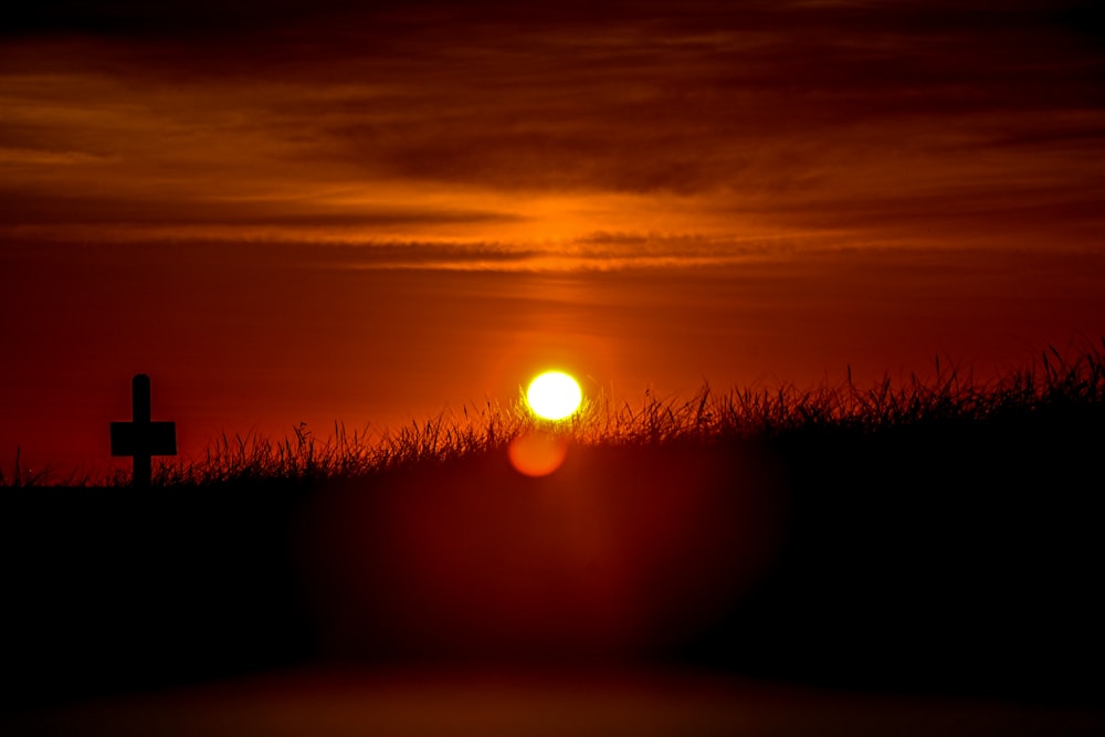 a sunset over a field