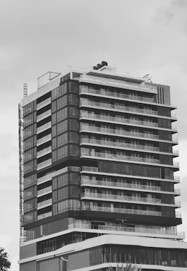 A sleek blueprint overlay on a modern architectural structure under construction.