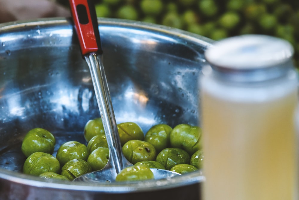 a bowl of olives and a jar of olives