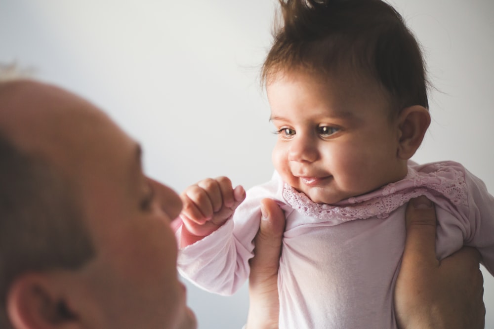 a little girl is looking at the camera