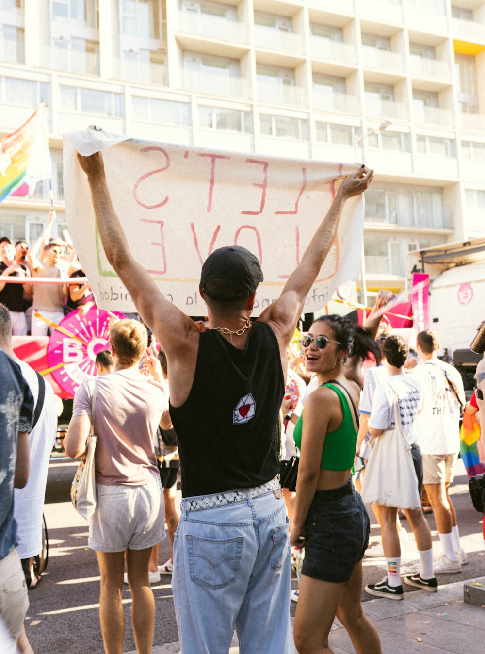 a person holding a sign in a crowd of people