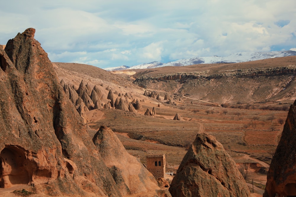 a large canyon with a few people walking through it